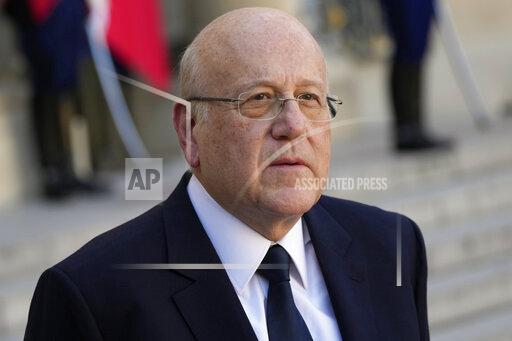 Lebanese Prime Minister Najib Mikati attends a joint press conference with French President Emmanuel Macron after their meeting at the Elysee Palace, in Paris, on Sept. 24, 2021. Pope Francis told Lebanon’s prime minister on Wednesday that he was praying that God would help Lebanon “get up” and get back on its feet following an unprecedented economic crisis that has thrown three quarters of the country’s 6 million people, including a million Syrian refugees, into poverty. Prime Minister Najib Mikati met privately with Francis for about 20 minutes and gave him a tile from a 19th century Beirut church that was seriously damaged in the August 2020 port explosion that killed 216 people and injured more than 6,000. (AP Photo/Francois Mori, File)