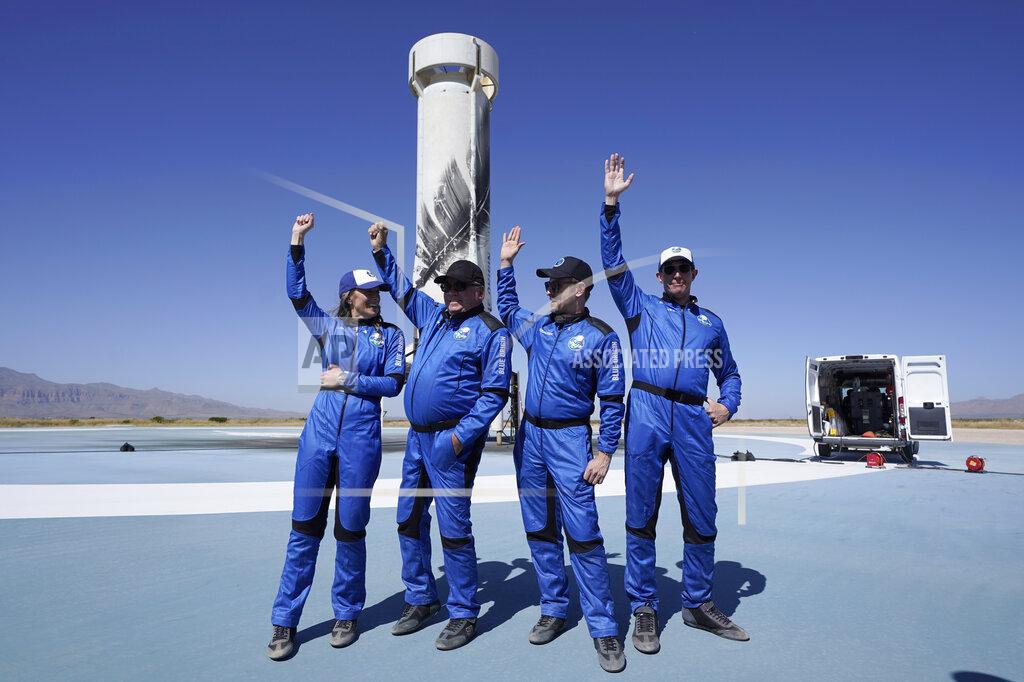 Lm Otero Blue Origin's New Shepard rocket latest space passengers from left, Audrey Powers, William Shatner, Chris Boshuizen, and Glen de Vries raise their hands during a media availability at the spaceport near Van Horn, Texas, Wednesday, Oct. 13, 2021. (AP Photo/LM Otero)