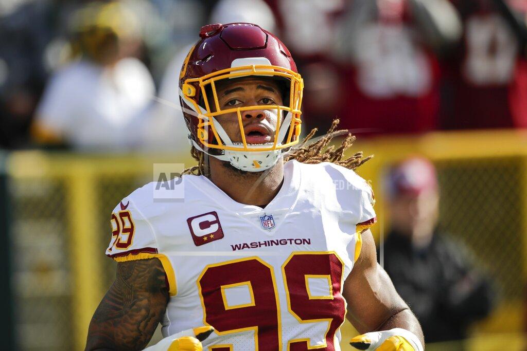 Aaron Gash Washington Football Team's Chase Young warms up before an NFL football game against the Green Bay Packers Sunday, Oct. 24, 2021, in Green Bay, Wis. (AP Photo/Aaron Gash)
