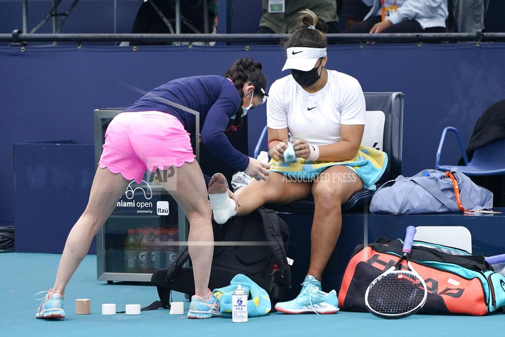Lynne Sladky Bianca Andreescu of Canada has her foot taped after she fell on the court during her finals match against Ashleigh Barty of Australia at the Miami Open tennis tournament, Saturday, April 3, 2021, in Miami Gardens, Fla. Barty won 6-3, 4-0, as Andreescu retired due to injury. (AP Photo/Lynne Sladky)