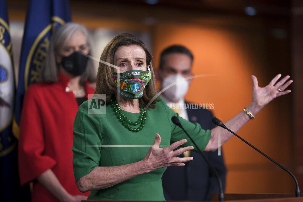 J. Scott Applewhite Speaker of the House Nancy Pelosi, D-Calif., meets with reporters before the House votes to pass a $1.9 trillion pandemic relief package, during a news conference at the Capitol in Washington, Friday, Feb. 26, 2021. Pelosi is flanked by Rep. Katherine Clark, D-Mass., left, and Rep. Pete Aguilar, D-Calif. (AP Photo/J. Scott Applewhite)