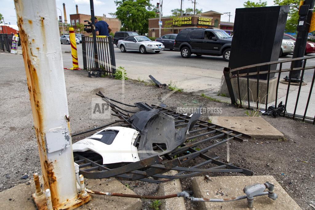 Brian Cassella A broken fence is left at a gas station in the 800 block of North Cicero Avenue on Thursday, May 19, 2022 where Chicago police shot a 13-year-old carjacking suspect Wednesday night. The Civilian Office of Police Accountability (COPA), the agency that investigates officer-involved shootings, said the shooting happened Wednesday night on the city's far West Side after officers spotted a vehicle matching the description of one used in a carjacking in the suburb of Oak Park. (Brian Cassella/Chicago Tribune via AP)