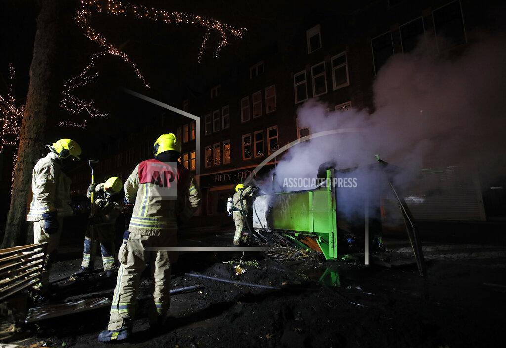 Peter Dejong A firefighter extinguishes a a container that was set alight during protests against a nation-wide curfew in Rotterdam, Netherlands, Monday, Jan. 25, 2021. The Netherlands Saturday entered its toughest phase of anti-coronavirus restrictions to date, imposing a nationwide night-time curfew from 9 p.m. until 4:30 a.m. in a bid to control the COVID-19 infection rate. (AP Photo/Peter Dejong)