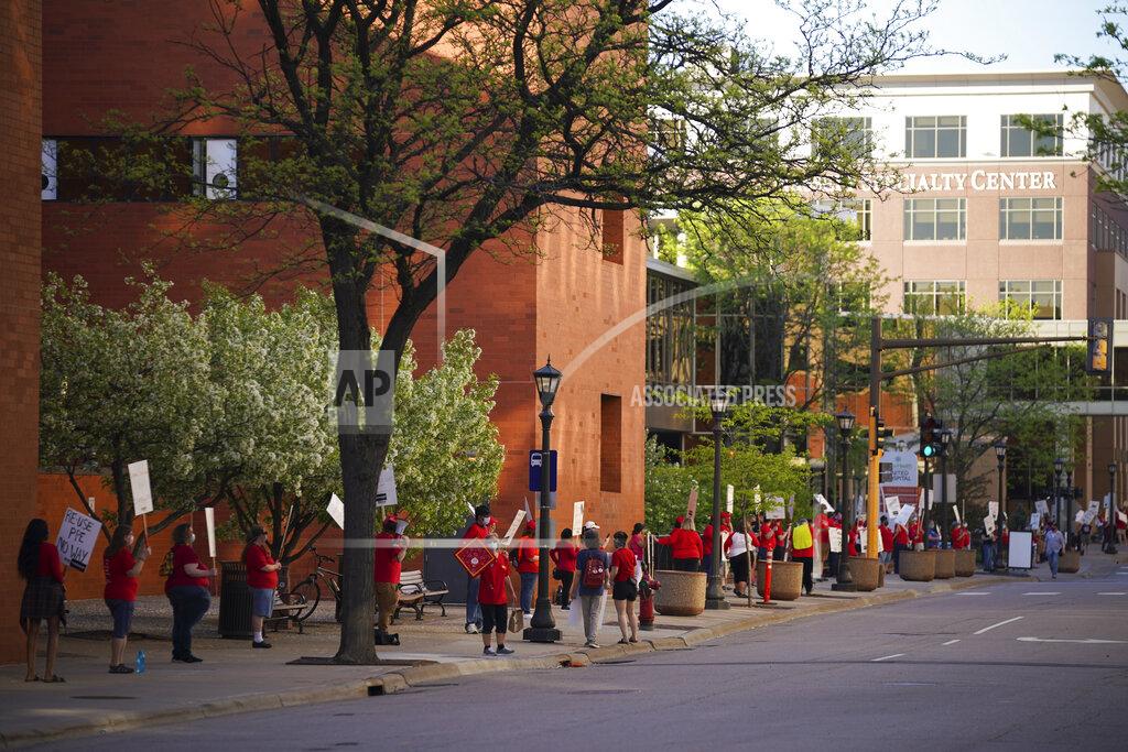 Jeff Wheeler Nurses picket at safe social distance from each other, Wednesday, May 20, 2020, in St. Paul, Minn., during an informational picket sponsored by the Minnesota Nurses Association along Smith Avenue, outside United Hospital. Nurse members are asking for a say in worker protections, increased PPE resources with higher safety standards and an end to retaliation against workers who have tried to protect themselves from the COVID-19 virus. After picketing, they marched to the State Capitol to hear speakers. (Jeff Wheeler/Star Tribune via AP)