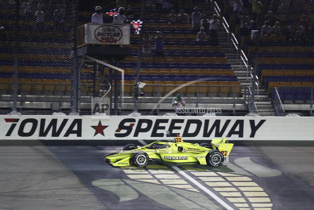 Charlie Neibergall Simon Pagenaud, of France, crosses the finish line as he wins an IndyCar Series auto race Friday, July 17, 2020, at Iowa Speedway in Newton, Iowa. (AP Photo/Charlie Neibergall)