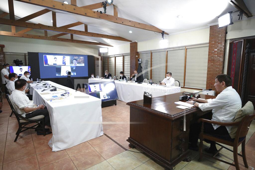 Alberto Alcain In this photo provided by the Malacanang Presidential Photographers Division, Philippine President Rodrigo Duterte, right, presides over a meeting with the Inter-Agency Task Force on the Emerging Infectious Diseases (IATF-EID) core members at the Malacanang presidential palace in Manila, Philippines Wednesday, May 5, 2021. The Philippine president has asked China to get back 1,000 doses of donated Sinopharm vaccine after facing criticisms for allowing himself to be injected with it although it has not yet been authorized for public use in the country. (Alberto Alcain/Malacanang Presidential Photographers Division via AP)