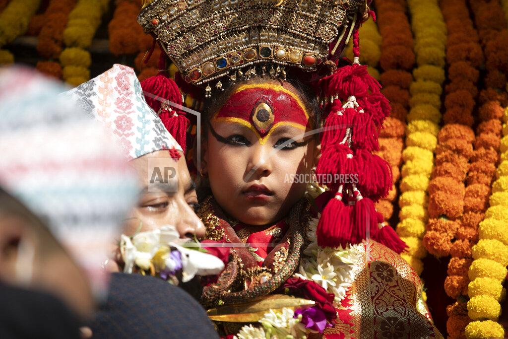 Niranjan Shrestha Nepal's revered living goddess Kumari is carried to be taken around in a wooden chariot during the annual Indra Jatra festival in Kathmandu, Nepal, Sunday, Sept. 19, 2021. The feast of Indra Jatra marks the return of the festival season in the Himalayan nation two years after it was scaled down because the pandemic. (AP Photo/Niranjan Shrestha)