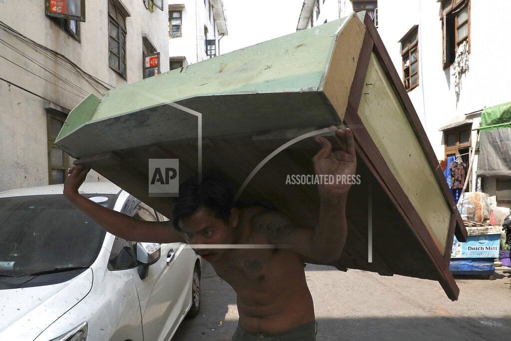 Uncredited A state railway employee carries a piece of furniture after being evicted from his home Saturday, March 20, 2021, in Mandalay, Myanmar. State railway workers in Mandalay have been threatened with eviction to force them to end their support for the Civil Disobedience Movement (CDM) against military rule. (AP Photo)