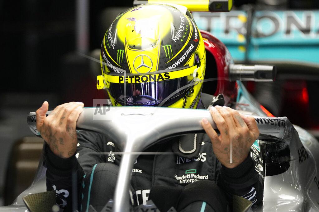 Manu Fernandez Mercedes driver Lewis Hamilton of Britain gets on board of his car during the qualifying session at the Barcelona Catalunya racetrack in Montmelo, Spain, Saturday, May 21, 2022. The Formula One race will be held on Sunday. (AP Photo/Pool/Manu Fernandez)
