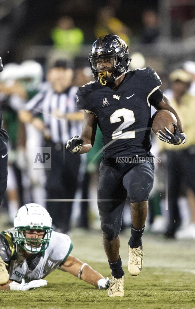 Central Florida running back Otis Anderson (2) sprints away from South Florida players during the second half of an NCAA college football game Friday, Nov. 29, 2019, in Orlando, Fla. (AP Photo/Willie J. Allen Jr.)
