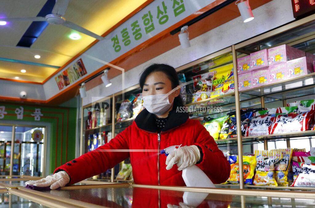 Cha Song Ho FILE - An employee of the Kyonghung Foodstuff General Store disinfects the showroom countertops in Pyongyang, North Korea, Wednesday, Nov. 10, 2021. Before acknowledging domestic COVID-19 cases, Thursday, May 12, 2022, North Korea spent 2 1/2 years rejecting outside offers of vaccines and steadfastly claiming that its superior socialist system was protecting its 26 million people from “a malicious virus” that had killed millions around the world. (AP Photo/Cha Song Ho, File)