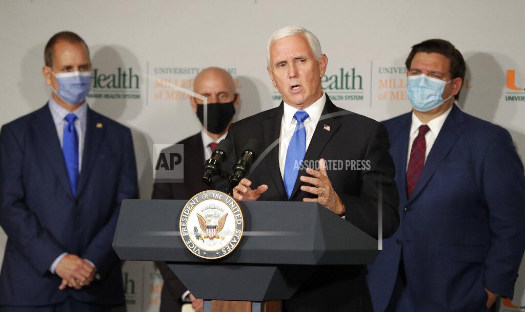 Wilfredo Lee Vice President Mike Pence, second from left, speaks during a news conference as Rep. Mario Diaz-Balart, R-Fla., left, Food and Drug Administration Commissioner Dr. Stephen Hahn, second from left, and Florida Gov. Ron DeSantis, right, look on at the University of Miami Miller School of Medicine
Don Soffer Clinical Research Center, Monday, July 27, 2020, in Miami. Pence was in Florida to mark the beginning of Phase III trials for a coronavirus vaccine. (AP Photo/Wilfredo Lee)