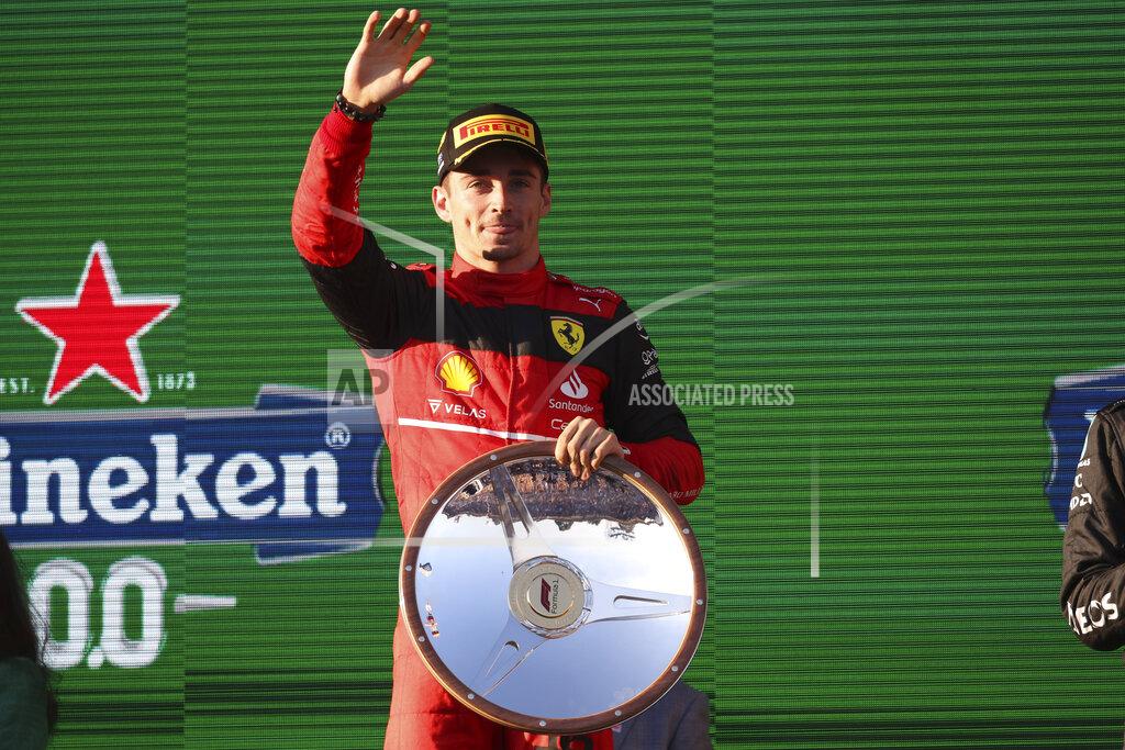 Asanka Brendon Ratnayake Ferrari driver Charles Leclerc of Monaco waves on the podium after winning the Australian Formula One Grand Prix in Melbourne, Australia, Sunday, April 10, 2022. (AP Photo/Asanka Brendon Ratnayake)