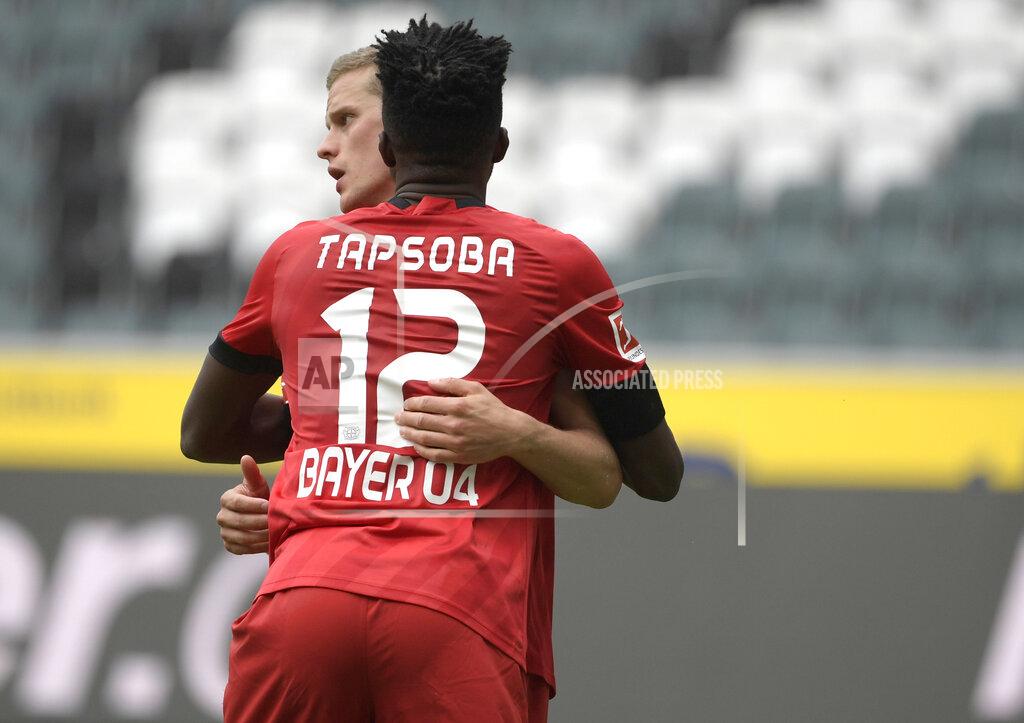 Ina Fassbender Leverkusen's Sven Bender celebrates with teammate Edmond Tapsoba after scoring, during the German Bundesliga soccer match between Borussia Moenchengladbach and Leverkusen, in Moenchengladbach, Germany, Saturday, May 23, 2020. (Ina Fassbender Pool Photo via AP)