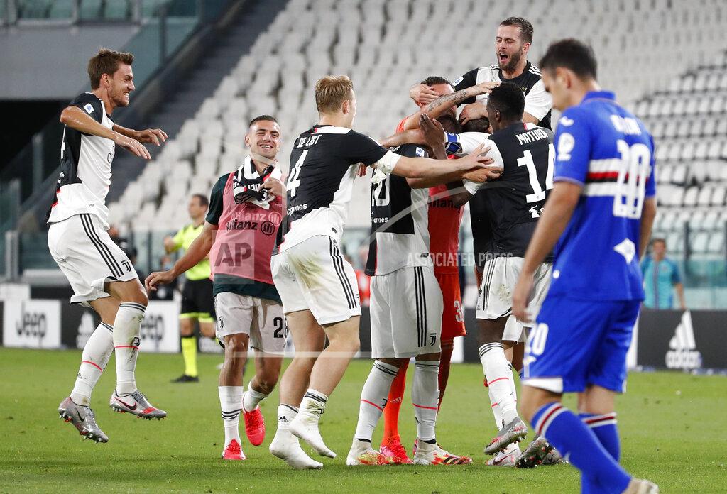 Antonio Calanni Juventus players celebrate at the end of Serie A soccer match between Juventus and Sampdoria at the Allianz stadium, in Turin, Italy, Sunday, July 26, 2020. Juventus clinched a record-extending ninth successive Serie A title, after it defeated Sampdoria 2-0. (AP Photo/Antonio Calanni)