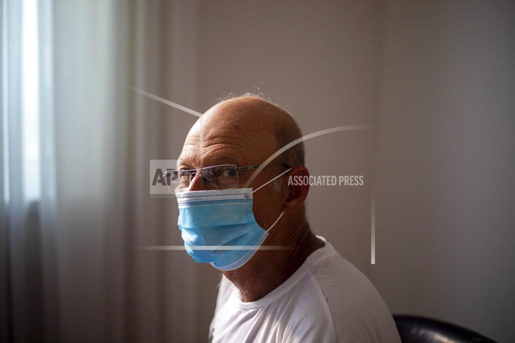 In this photo taken on Sunday, June 28, 2020, former Israeli Air Force general and leading critic of Prime Minister Benjamin Netanyahu, Brig. Gen. Amir Haskel wears a face mask amid the concerns over the country's coronavirus outbreak pose for a photo in Tel Aviv, Israel. After 32 years in the Israeli Air Force, retired Brig. Gen. Amir Haskel wasn't looking to politics. But as his prime minister became further enmeshed in corruption, he felt he could no longer stay silent. So, he picked up a sign and took to the streets in an individual act of protest. Now, after his highly-publicized weekend arrest during a peaceful demonstration, he has become the unquestioned leader of the growing grassroots movement demanding that Benjamin Netanyahu step down. (AP Photo/Ariel Schalit)