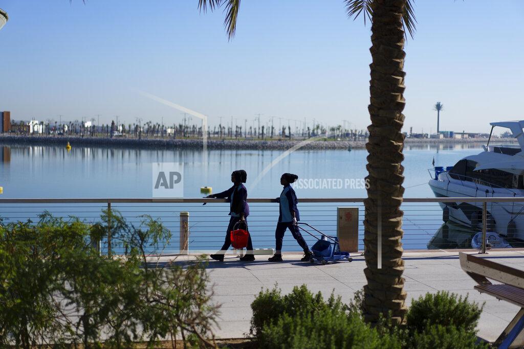 Pavel Golovkin Municipal workers clean a handrail at Lusail Marina Corniche in Lusail downtown, Qatar, Thursday, Nov. 24, 2022. (AP Photo/Pavel Golovkin)