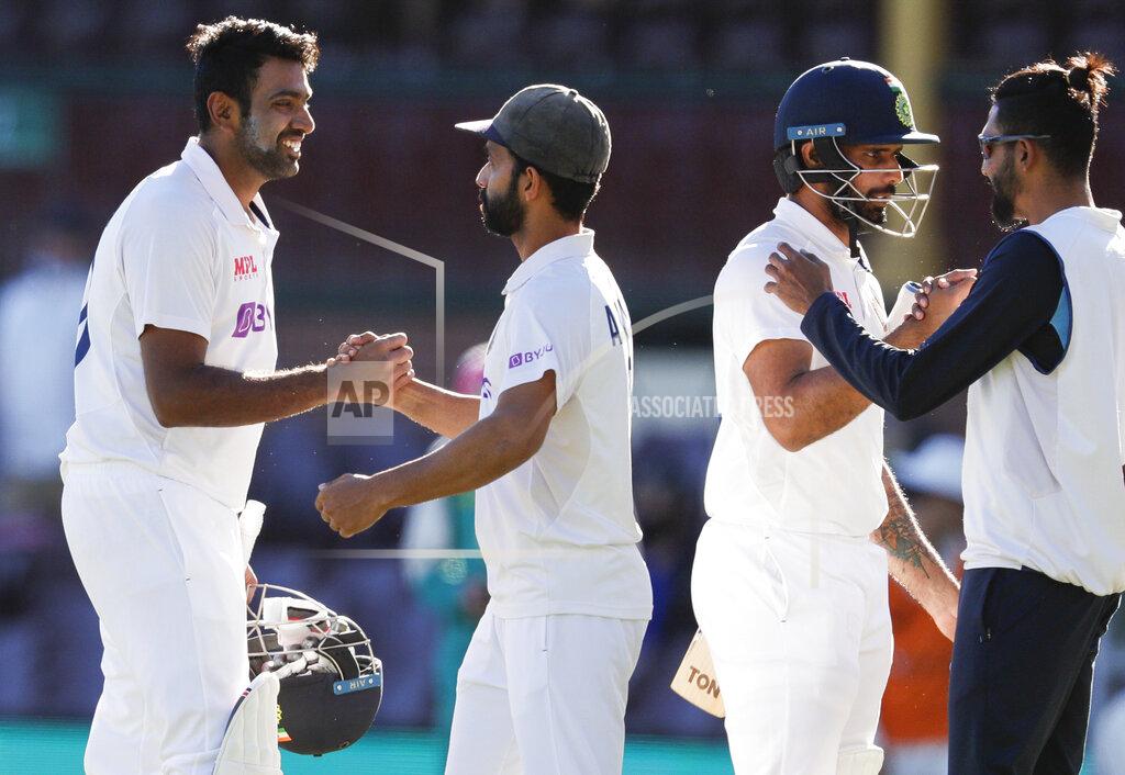 Rick Rycroft India's Ravichandran Ashwin, left, is congratulated by his captain Ajinkya Rahane as Hanuma Vihari is congratulated by teammate Mohammed Siraj, right, following play on the final day of the third cricket test between India and Australia at the Sydney Cricket Ground, Sydney, Australia, Monday, Jan. 11, 2021. The test ended in a draw and the series is at 1-1 all with one test to play. (AP Photo/Rick Rycroft)