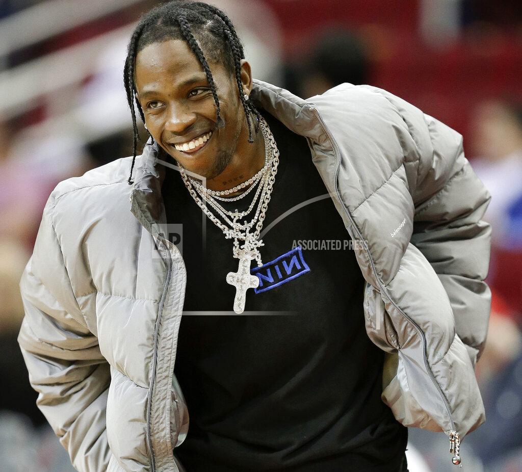 Eric Christian Smith FILE - In this Feb. 9, 2018, file photo, hip hop artist Travis Scott watches warmups before an NBA basketball game between the Houston Rockets and the Denver Nuggets, in Houston. Scott and Jermaine Dupri have been criticized for taking part in Super Bowl-related events, but their shows among others will still go on. Dupri will host a concert series called Super Bowl Live while Scott is expected to perform at the Pepsi Super Bowl Party two days before performing at Super Bowl 53 on Sunday, Feb. 3, 2019. (AP Photo/Eric Christian Smith, File)