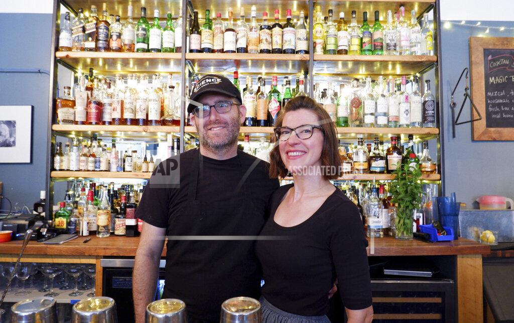Ed Komenda Jake Cerese and Kate Claeys pose for a photo at their restaurant and bar, Kerouac's, Wednesday, June 23, 2021 in rural Baker, Nev. The couple gave up urban life in New York City back in 2017 to move to to the remote area near Great Basin National Park. (Ed Komenda/The Reno Gazette-Journal via AP)