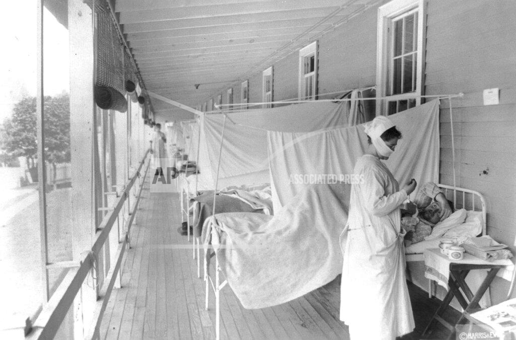 Library Of Congress FILE - In this November 1918 photo made available by the Library of Congress, a nurse takes the pulse of a patient in the influenza ward of the Walter Reed hospital in Washington. Historians think the pandemic started in Kansas in early 1918, and by winter 1919 the virus had infected a third of the global population and killed at least 50 million people, including 675,000 Americans. Some estimates put the toll as high as 100 million. (Harris & Ewing/Library of Congress via AP, File)