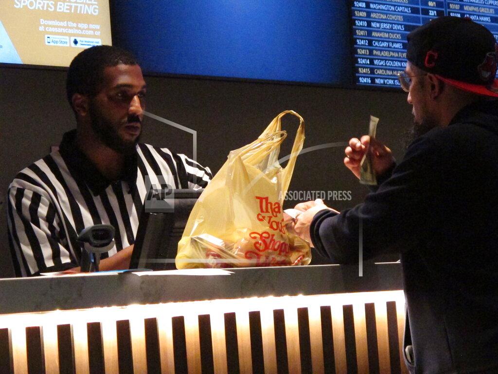 Wayne Parry FILE - A gambler makes a sports bet at Bally's casino in Atlantic City N.J., Sept. 5, 2019. A record 31.5 million Americans plan to bet on this year's Super Bowl, according to the gambling industry's national trade group. The American Gaming Association on Tuesday, Feb. 8, 2022, released its annual predictions for wagering on pro football's championship game, forecasting that over $7.6 billion will be bet legally and otherwise. (AP Photo/Wayne Parry, File)