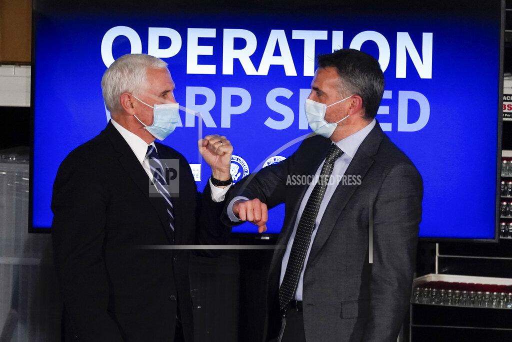 Darron Cummings Vice President Mike Pence elbow bumps Alessandro Maselli, President and Chief Operating Officer at Catalent, following a round table discussion at Catalent Biologics, Tuesday, Dec. 15, 2020, in Bloomington, Ind. (AP Photo/Darron Cummings)