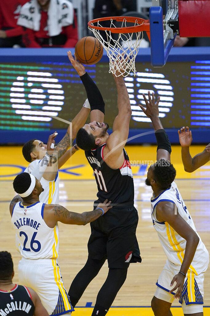 Tony Avelar Portland Trail Blazers center Enes Kanter (11) reacts as he is fouled by Golden State Warriors forward Kevon Looney, right, during the first half of an NBA basketball game in San Francisco, Friday, Jan. 1, 2021. (AP Photo/Tony Avelar)
