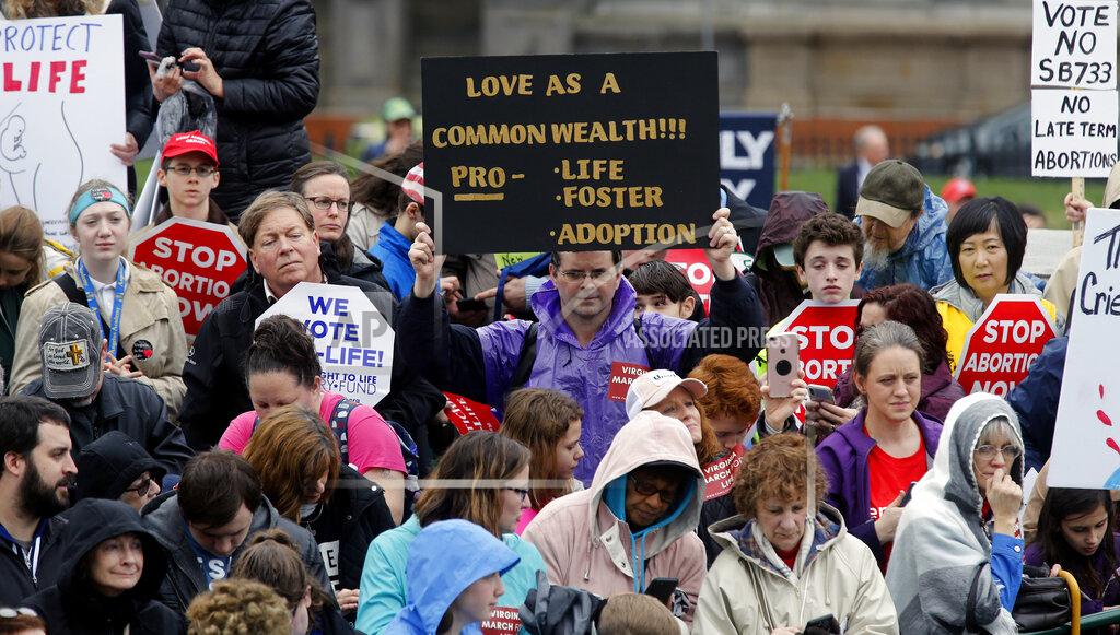 Bob Brown FILE - In this Feb. 13, 2020, file photo, demonstrators hold up a signs during the Virginia March for Life rally outside the Virginia State Capitol in Richmond, Va. Anti-abortion leaders across America were elated a year ago when Donald Trump became the first sitting U.S. president to appear in person at their highest-profile annual event, the March for Life held every January. The mood is more sober now — a mix of disappointment over Trump’s defeat and hope that his legacy of judicial appointments will lead to future court victories limiting abortion rights. (Bob Brown/Richmond Times-Dispatch via AP, File)