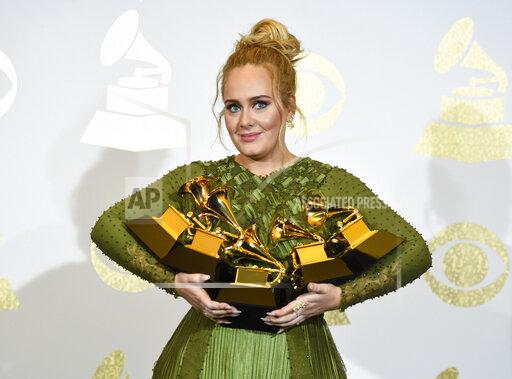 FILE - Adele poses in the press room with the awards for album of the year for "25", song of the year for "Hello", record of the year for "Hello", best pop solo performance for "Hello", and best pop vocal album for "25" at the Grammy Awards in Los Angeles on Feb. 12, 2017. Adele announced on Instagram that her “30” album will come out November 19. A new single, ‘Easy on Me,’ is being released on Friday.(Photo by Chris Pizzello/Invision/AP, File)