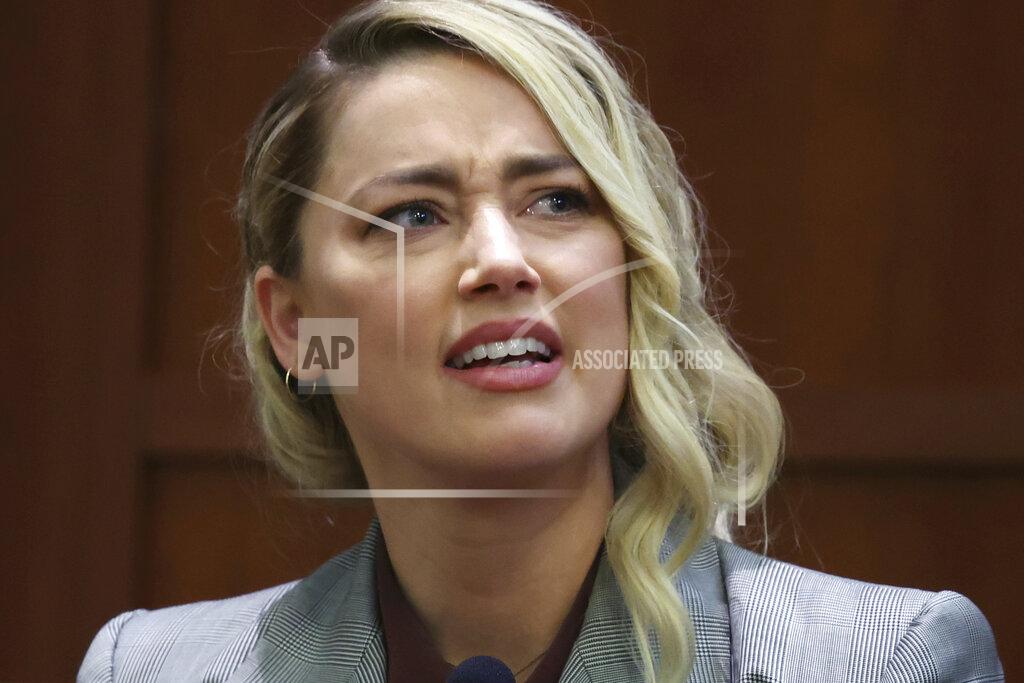 Michael Reynolds Actor Amber Heard testifies in the courtroom in the Fairfax County Circuit Courthouse in Fairfax, Va., Thursday, May 26, 2022. Actor Johnny Depp sued his ex-wife Amber Heard for libel in Fairfax County Circuit Court after she wrote an op-ed piece in The Washington Post in 2018 referring to herself as a "public figure representing domestic abuse." (Michael Reynolds/Pool Photo via AP)