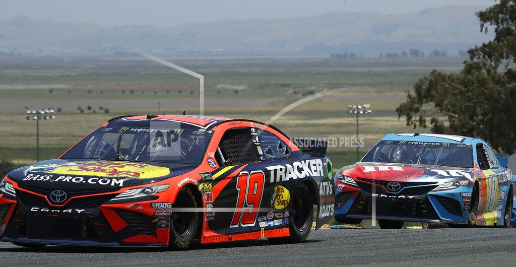 Ben Margot Martin Truex Jr. (19) leads Kyle Busch through a turn during a NASCAR Sprint Cup Series auto race Sunday, June 23, 2019, in Sonoma, Calif. (AP Photo/Ben Margot)