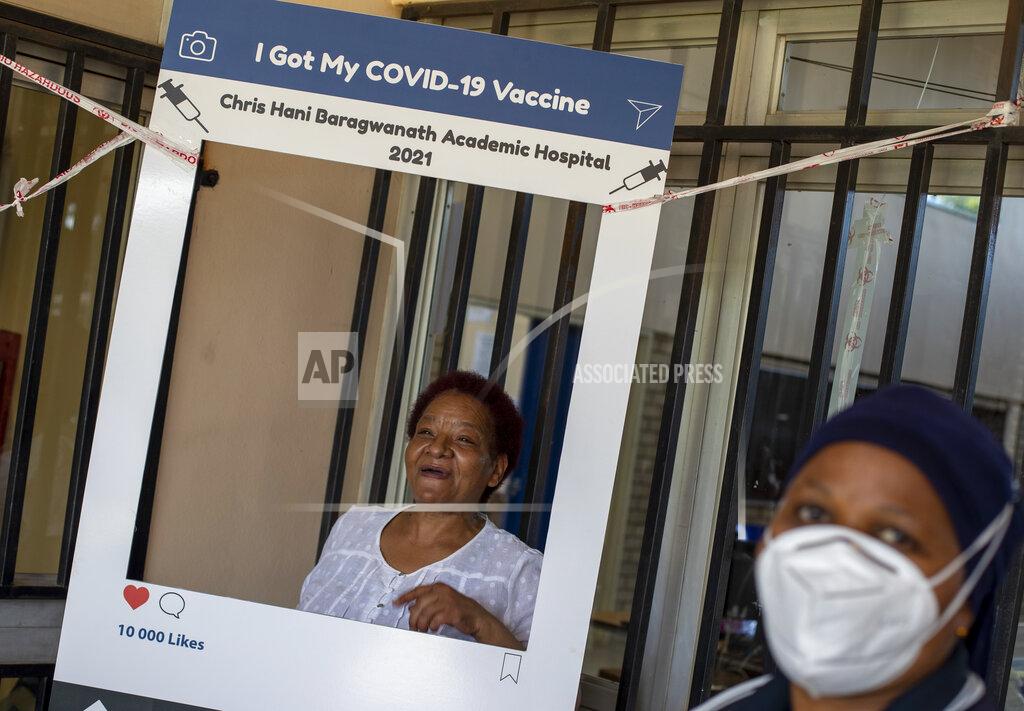 Themba Hadebe Maggie Sedidi, a 59-year-old nurse at Soweto's Chris Hani Baragwanath hospital, poses for a photo taken by a colleague after receiving her dose of the Johnson & Johnson COVID-19 vaccine from a health staff member at a vaccination center in Soweto, South Africa, Friday, March 5, 2021. Sedidi is optimistic: "By next year, or maybe the year after, I really do hope that people will be able to begin returning to normal life." (AP Photo/Themba Hadebe)