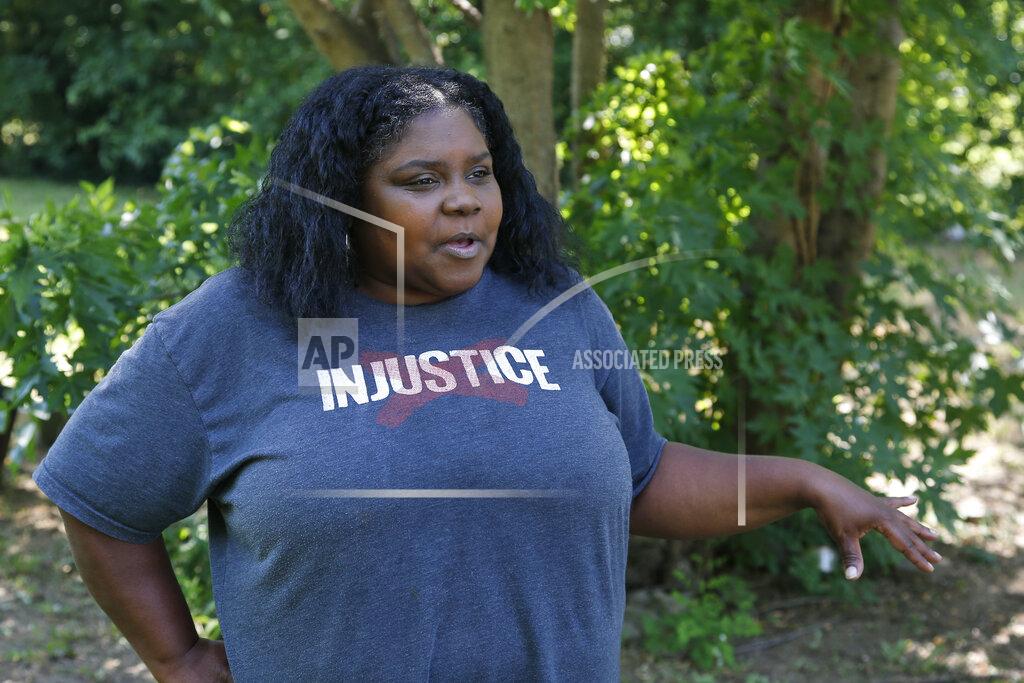 Sue Ogrocki Kristi Williams answers a question during an interview at her home in Tulsa, Okla., Monday, June 15, 2020. Williams' great-aunt fled with a date from the theater when the armed whites came to destroy the black part of town in 1921. (AP Photo/Sue Ogrocki)