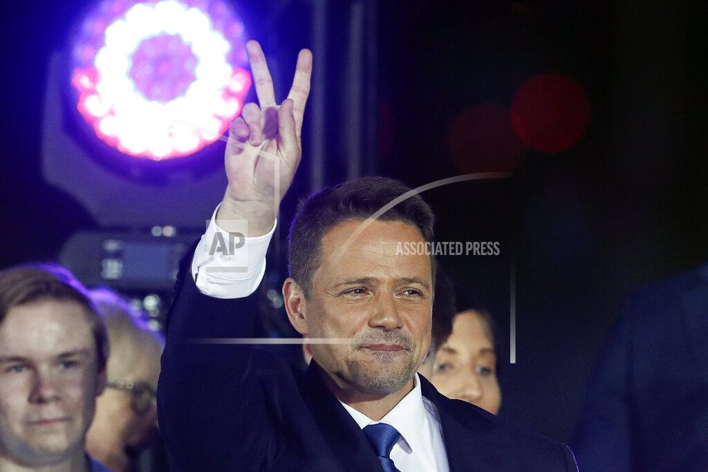 Petr David Josek Presidential candidate Rafal Trzaskowski flashes a victory sign at the end of the election day in Warsaw, Poland, Sunday, July 12, 2020. Voting ended in Poland's razor-blade-close presidential election runoff between the conservative incumbent Andrzej Duda and liberal, pro-European Union Warsaw Mayor Rafal Trzaskowski with exit polls showing the election is too close to call. (AP Photo/Petr David Josek)
