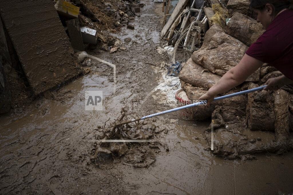 Bram Janssen FILE - In this Monday, July 19, 2021 file photo, a woman tries to clean the mud in front of her house in Bad Neuenahr-Ahrweiler, Germany. Scientists say there’s something different this year from the recent drumbeat of climate weirdness. This summer a lot of the places hit by weather disasters are not used to getting extremes and many of them are wealthier, which is different from the normal climate change victims. That includes unprecedented deadly flooding in Germany and Belgium, 116-degree heat records in Portland, Oregon and similar blistering temperatures in Canada, along with wildfires. Now Southern Europe is seeing scorching temperatures and out-of-control blazes too. And the summer of extremes is only getting started. Peak Atlantic hurricane and wildfire seasons in the United States are knocking at the door. (AP Photo/Bram Janssen, File)