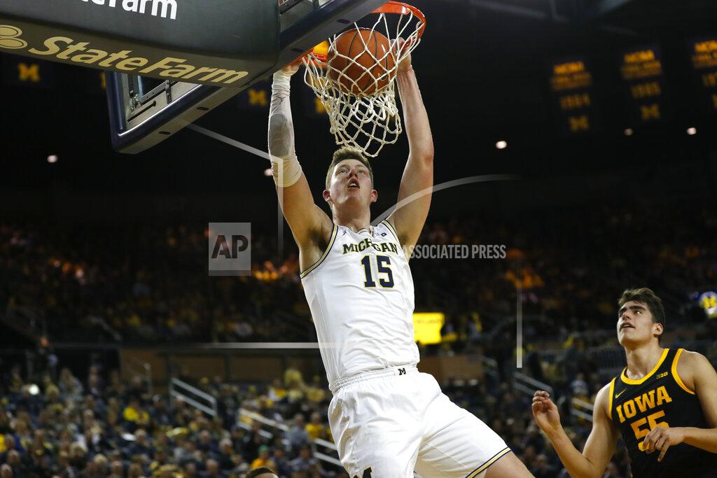 Paul Sancya Michigan center Jon Teske (15) dunks against Iowa center Luka Garza (55) in the first half of an NCAA college basketball game in Ann Arbor, Mich., Friday, Dec. 6, 2019. (AP Photo/Paul Sancya)
