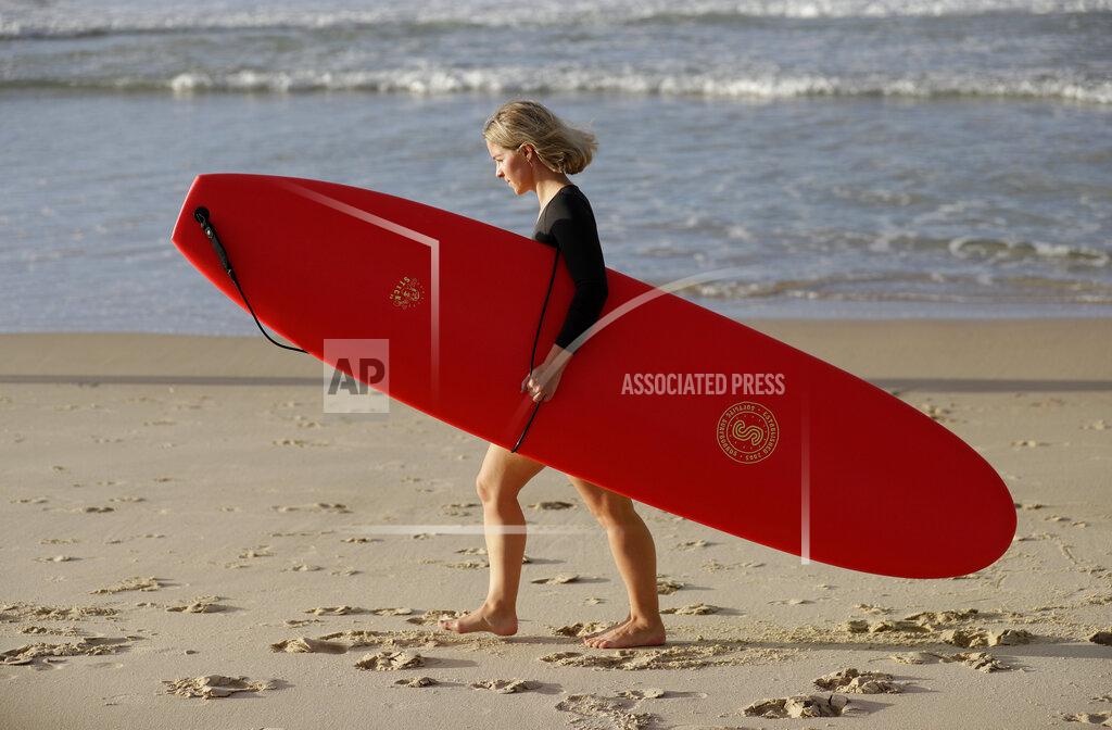 Rick Rycroft A surfer prepares to enter the water at Bondi Beach in Sydney, Tuesday, April 28, 2020, as coranavirus pandemic restrictions are eased. The beach is open to swimmers and surfers to exercise only. (AP Photo/Rick Rycroft)