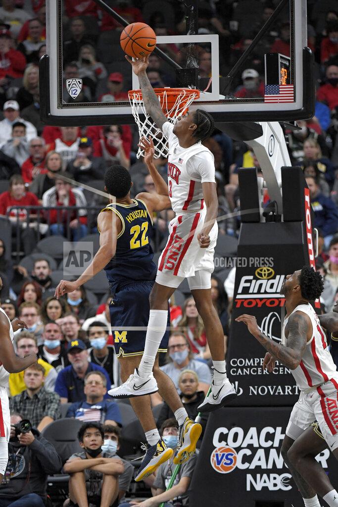 David Becker UNLV forward Donovan Williams (3) blocks a shot by Michigan forward Caleb Houstan (22) during the first half of an NCAA college basketball game Friday, Nov. 19, 2021, in Las Vegas. (AP Photo/David Becker)