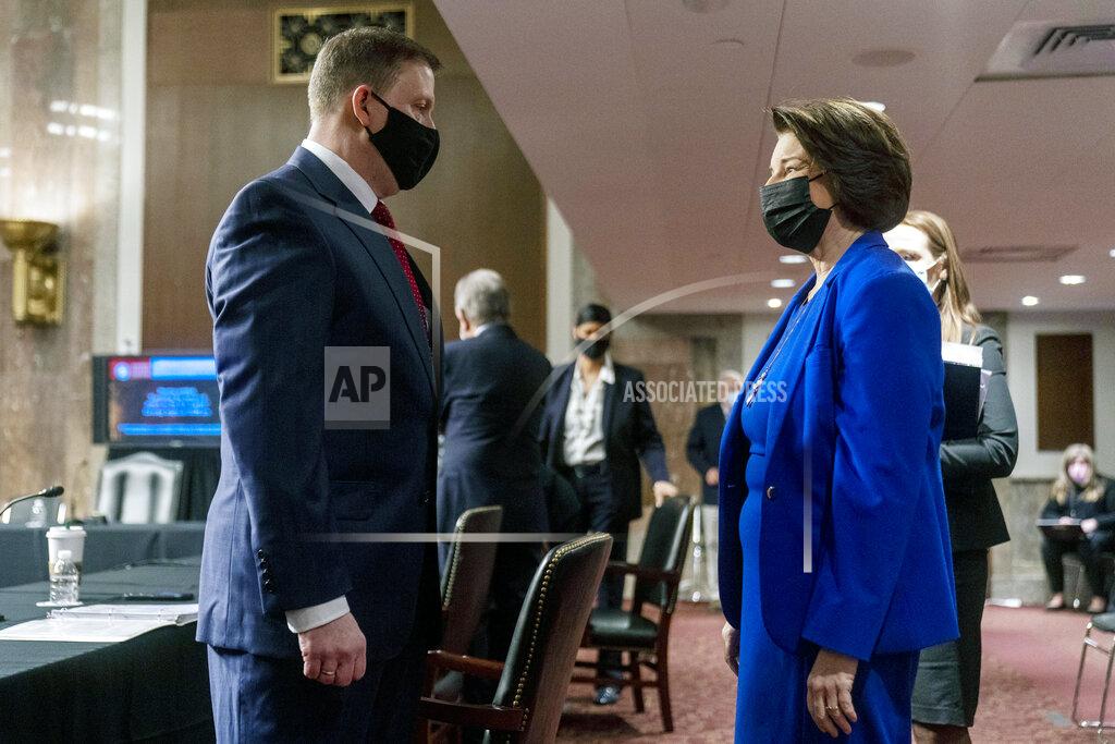Andrew Harnik Former U.S. Capitol Police Chief Steven Sund, left, speaks with Chairwoman Sen. Amy Klobuchar, D-Minn., right, before he testifies before a Senate Homeland Security and Governmental Affairs & Senate Rules and Administration joint hearing on Capitol Hill, Washington, Tuesday, Feb. 23, 2021, to examine the January 6th attack on the Capitol. (AP Photo/Andrew Harnik, Pool)