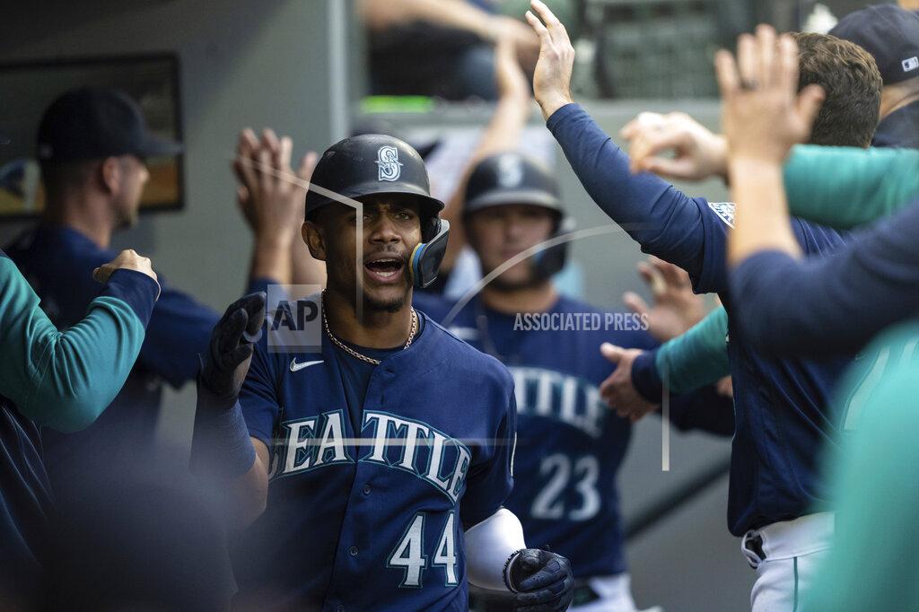 Stephen Brashear Seattle Mariners' Julio Rodriguez celebrates in the dugout after hitting a three-run home run off Oakland Athletics starting pitcher Matthew Festa during the third inning of a baseball game, Monday, May 23, 2022, in Seattle. The hit also scored Mariners' J.P. Crawford and Ty France. (AP Photo/Stephen Brashear)