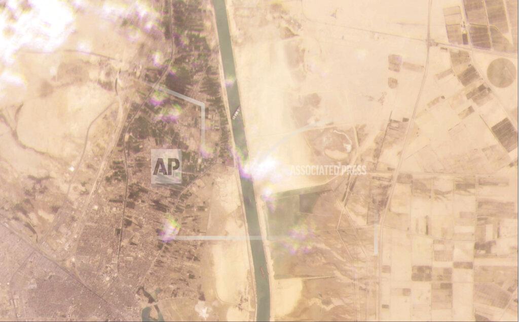 Planet Labs Inc. This satellite image from Planet Labs Inc. shows the cargo ship MV Ever Given stuck in the Suez Canal near Suez, Egypt, Tuesday, March 23, 2021. A cargo container ship that's among the largest in the world has turned sideways and blocked all traffic in Egypt's Suez Canal, officials said Wednesday, March 24, 2021, threatening to disrupt a global shipping system already strained by the coronavirus pandemic. (Planet Labs Inc. via AP)