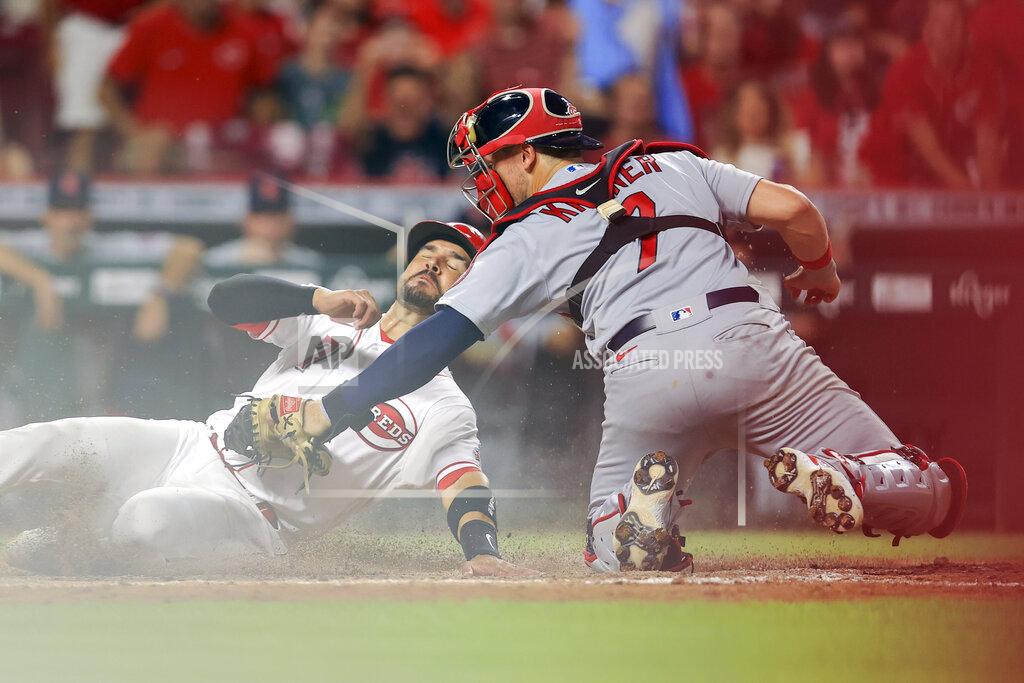 Aaron Doster Cincinnati Reds' Eugenio Suarez, left, is out at home plate as St. Louis Cardinals' Andrew Knizner, right, tags him during the seventh inning of a baseball game in Cincinnati, Friday, July 23, 2021. (AP Photo/Aaron Doster)