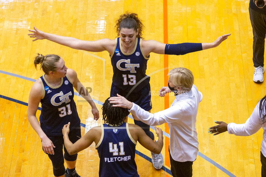 Stephen Spillman Georgia Tech guard Lotta-Maj Lahtinen (31), forward Lorela Cubaj (13), guard Kierra Fletcher (41) and coach Nell Fortner celebrate the team's 73-56 win over West Virginia in a college basketball game during the second round of the NCAA women's tournament at the UTSA Convocation Center in San Antonio on Tuesday, March 23, 2021. (AP Photo/Stephen Spillman)