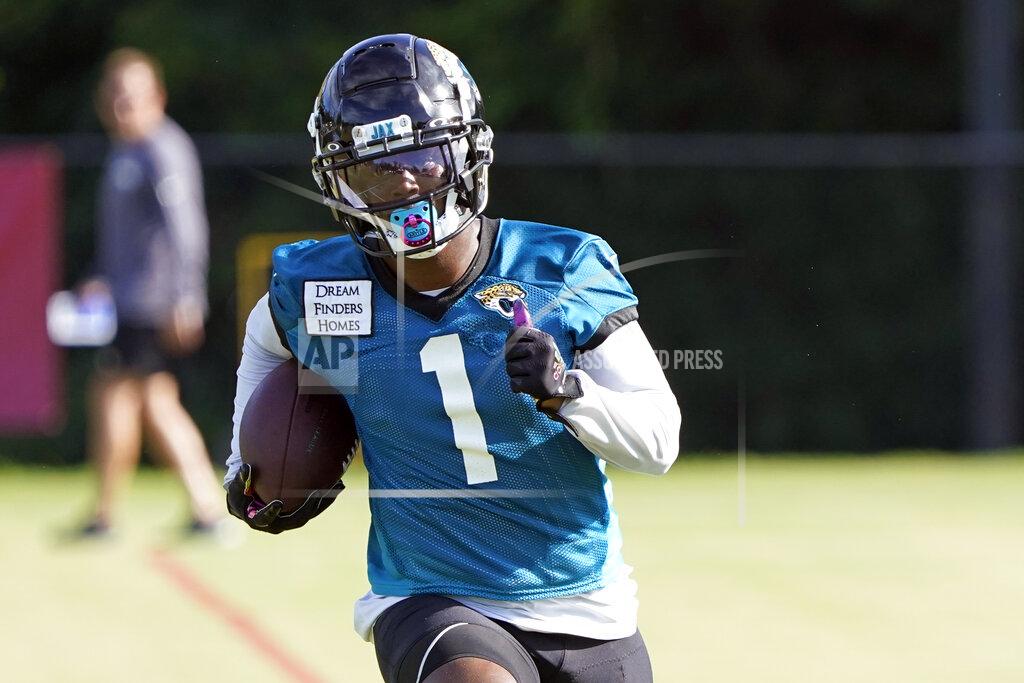 John Raoux Jacksonville Jaguars running back Travis Etienne (1) runs after a reception during an NFL football practice, Tuesday, July 26, 2022, in Jacksonville, Fla. (AP Photo/John Raoux)