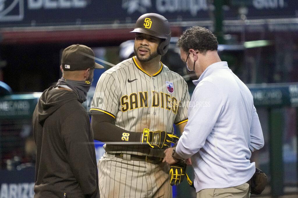 Rick Scuteri San Diego Padres' Tommy Pham, center, talks with trainers in the ninth inning during a baseball game against the Arizona Diamondbacks, Sunday, Aug 16, 2020, in Phoenix. Pham would leave the game with a two-strike count. (AP Photo/Rick Scuteri)