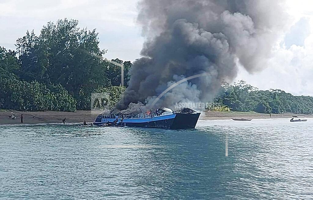 Uncredited In this handout provided by the Philippine Coast Guard, smoke billows from ferry M/V Mercraft 2 as it's towed to an island off the town of Real, Quezon province, Philippines on Monday, May 23, 2022. The passenger ship caught fire as it neared it's port of destination in Real killing several people on board. (Philippine Coast Guard via AP Photo)
