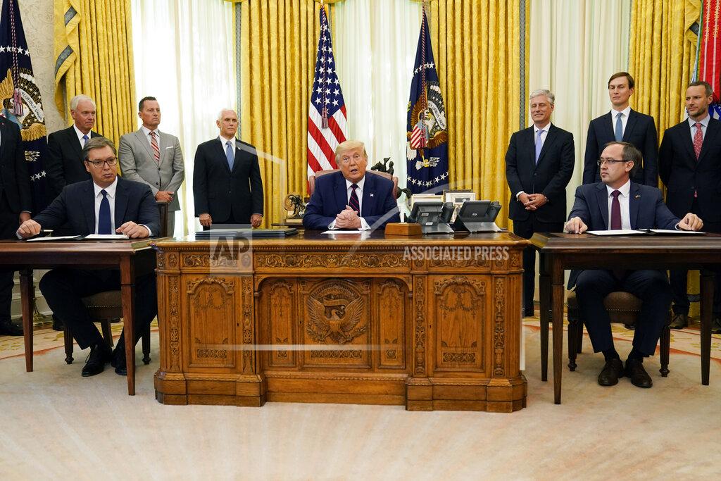 Evan Vucci FILE - In this Sept. 4, 2020 file photo President Donald Trump participates in a signing ceremony with Serbian President Aleksandar Vucic, seated left, and Kosovar Prime Minister Avdullah Hoti, seated right, in the Oval Office of the White House, in Washington. For some Serbian leaders, U.S. President Donald Trump is a hero while his challenger Joe Biden is nothing but a "Serb hater." So, there is no surprise that Serbs living in the U.S. were called on to vote for Trump in Tuesday's election nor that Serbia's populist president said his victory would be better for the country.(AP Photo/Evan Vucci, File)
