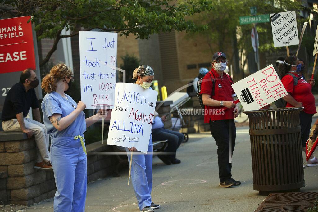 Jim Mone Nurses picket United Hospital, Wednesday, May 20, 2020, in St. Paul, Minn., as they seek a say in worker protections, increased personal protection resources with higher safety standards and an end to retaliation against workers who have tried to protect themselves from the coronavirus. (AP Photo/Jim Mone)