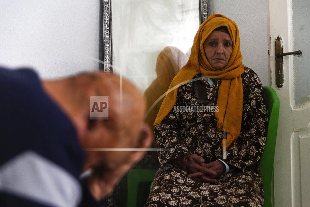 Riadh Dridi Zina Sehi, right, looks at her son, Hosni Kalaia, in Kasserine, Tunisia, on Friday, Dec. 11, 2020. Sehi and Kalaia are among hundreds of Tunisians who have turned to the desperate act of self-immolation in the past 10 years as a form of protest, following the example of Mohammed Bouazizi, a 26-year-old fruit seller who set himself ablaze on Dec. 17, 2010, to demonstrate against police harassment.(AP Photo/Riadh Dridi)